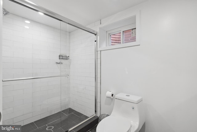 bathroom featuring an enclosed shower and toilet