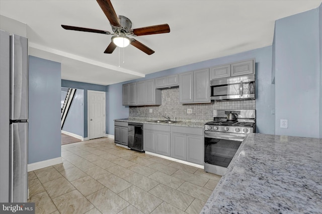 kitchen featuring light tile floors, tasteful backsplash, ceiling fan, and appliances with stainless steel finishes