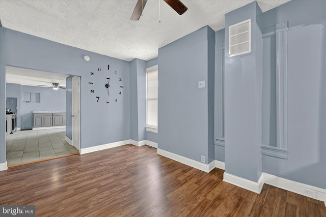 foyer featuring light tile floors, ceiling fan, and a textured ceiling