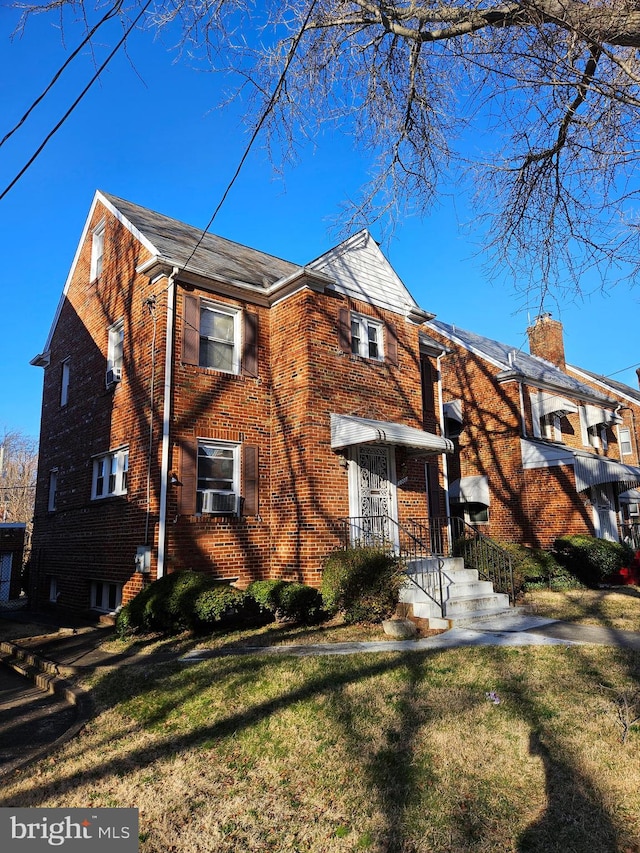 view of side of property with a lawn