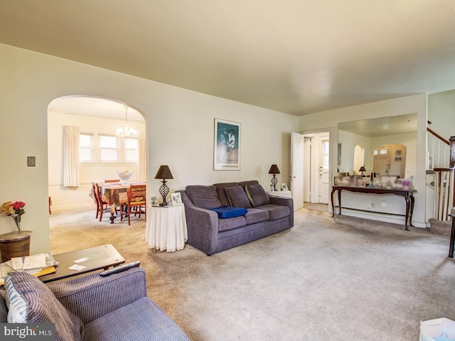 living room featuring light colored carpet and an inviting chandelier