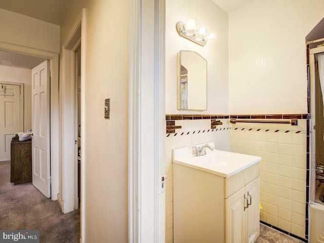 bathroom with tile walls and vanity