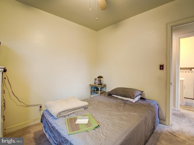 bedroom with light carpet, ensuite bathroom, and ceiling fan