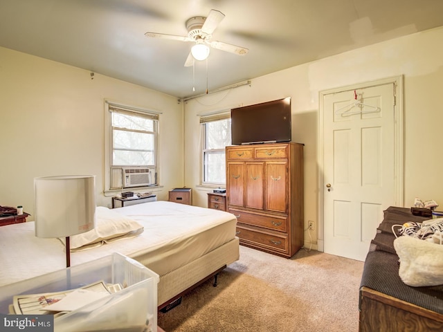 bedroom with ceiling fan and light carpet