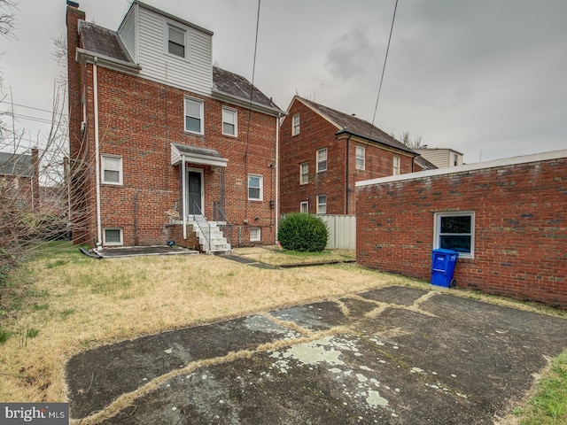 back of house with a yard