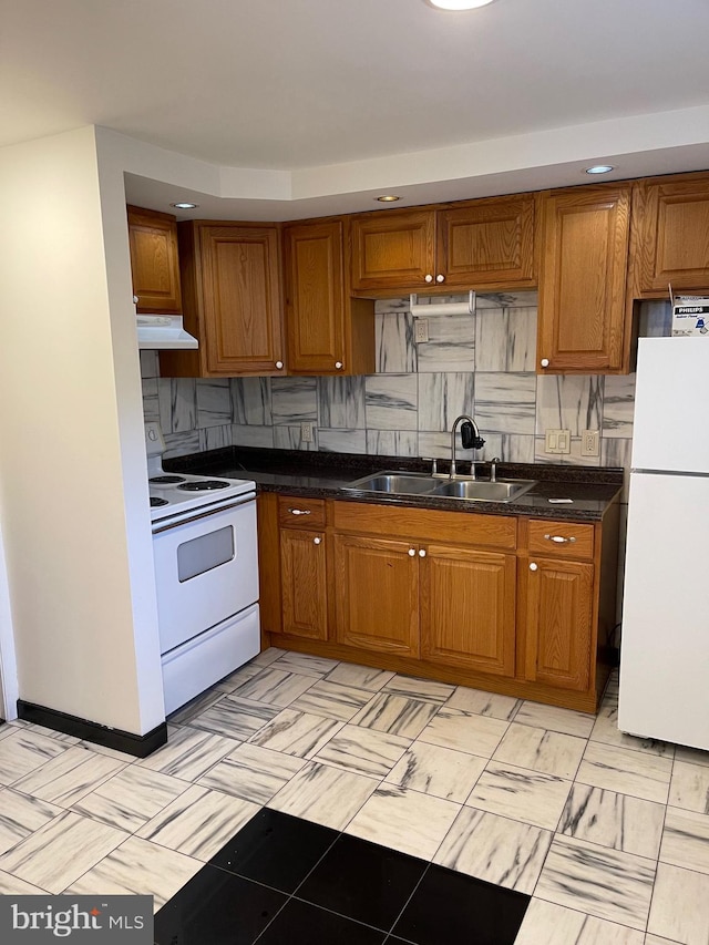 kitchen featuring light tile floors, tasteful backsplash, white appliances, and sink