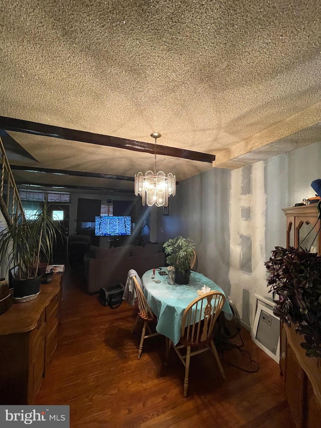 dining space featuring a textured ceiling, an inviting chandelier, and dark hardwood / wood-style flooring