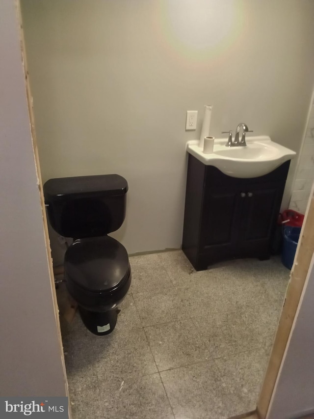 bathroom with vanity, tile floors, and toilet