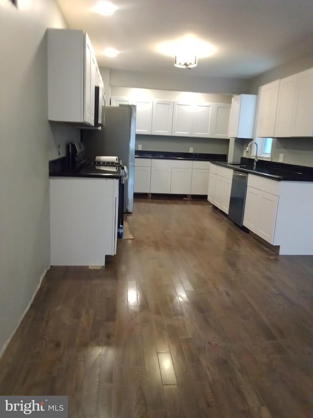 kitchen with dark hardwood / wood-style floors, sink, white cabinets, and dishwasher