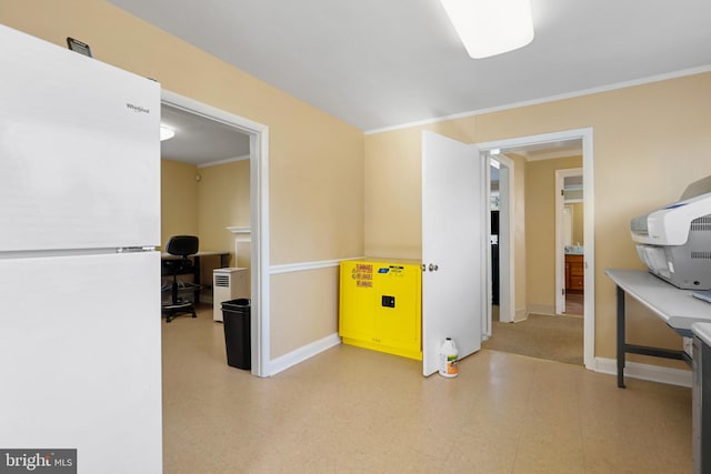 corridor with light tile flooring and ornamental molding