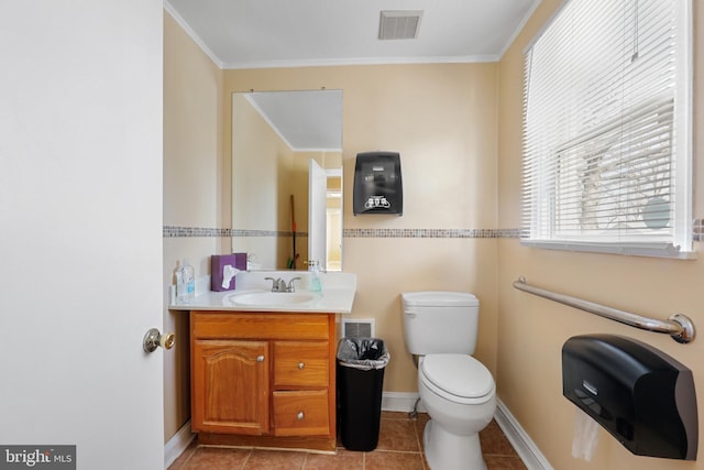 bathroom with toilet, ornamental molding, tile floors, and oversized vanity