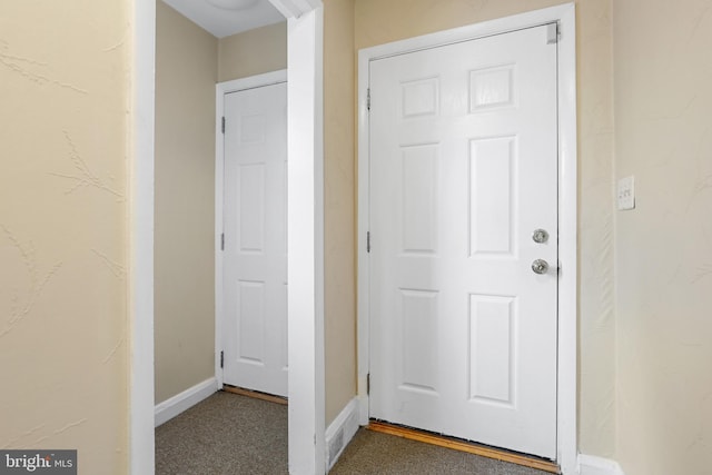 interior space with dark colored carpet