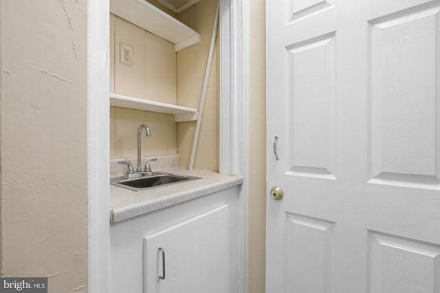 clothes washing area with sink