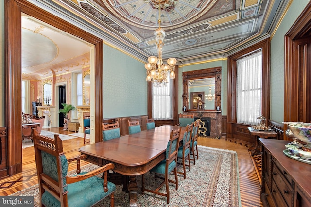 dining space featuring a notable chandelier, crown molding, and a raised ceiling