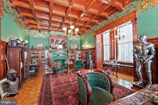 living room with an inviting chandelier, beam ceiling, a fireplace, coffered ceiling, and wood ceiling