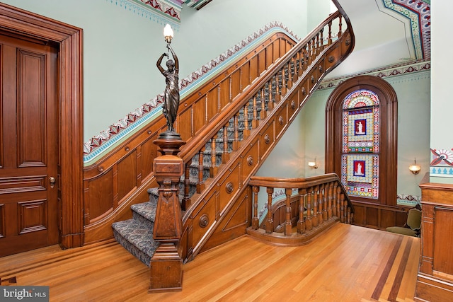 stairway with light hardwood / wood-style flooring