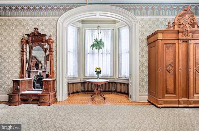 interior space with light parquet floors and radiator heating unit