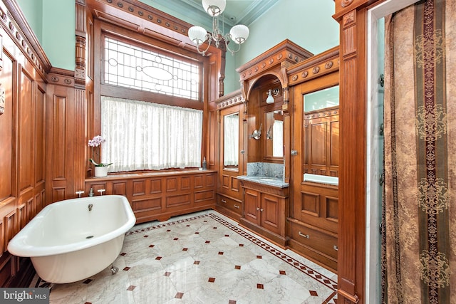 bathroom featuring a washtub, ornamental molding, a chandelier, tile floors, and vanity