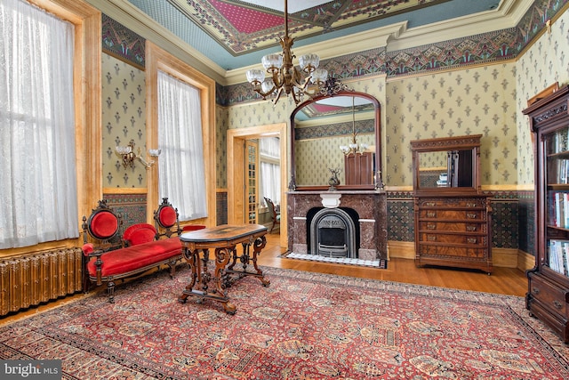 living room with crown molding, coffered ceiling, dark wood-type flooring, and a chandelier