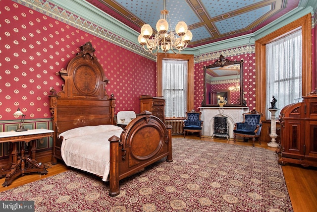 bedroom featuring an inviting chandelier, coffered ceiling, dark hardwood / wood-style floors, and ornamental molding