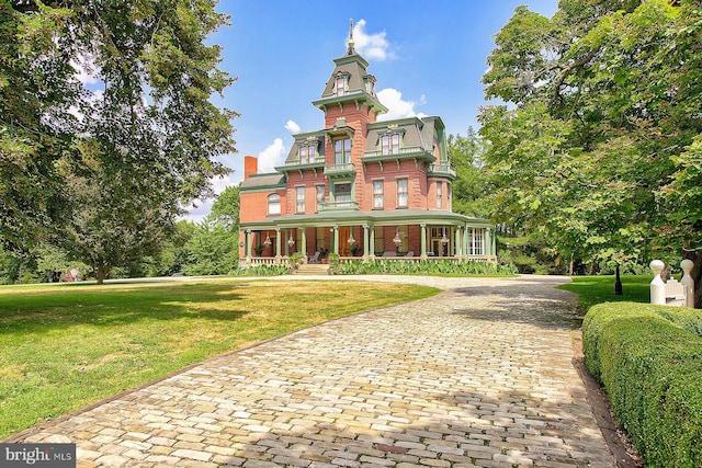 view of front of property with a front lawn and a balcony