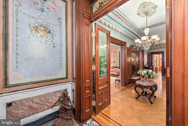 hallway with a chandelier, light parquet floors, and ornamental molding