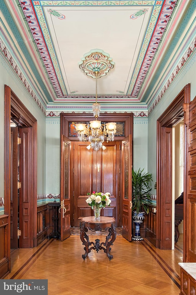 interior space with light parquet flooring and a notable chandelier