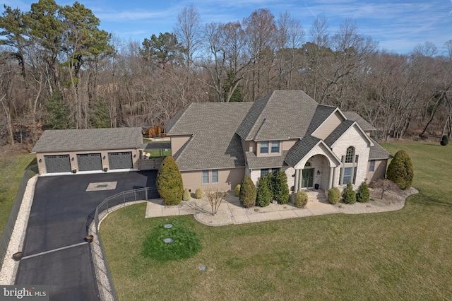 view of front of house with a front lawn and a garage