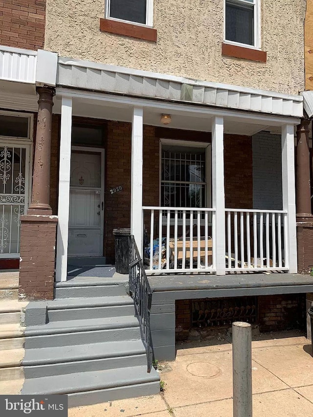 doorway to property with a porch