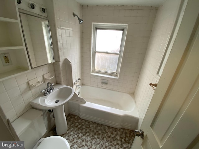 bathroom with tile walls, tiled shower / bath combo, toilet, backsplash, and tile flooring