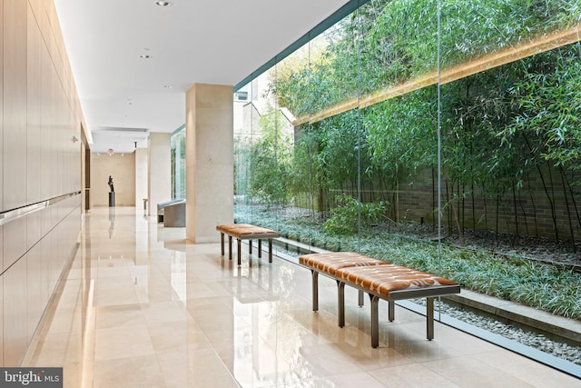 exterior space featuring expansive windows and light tile floors