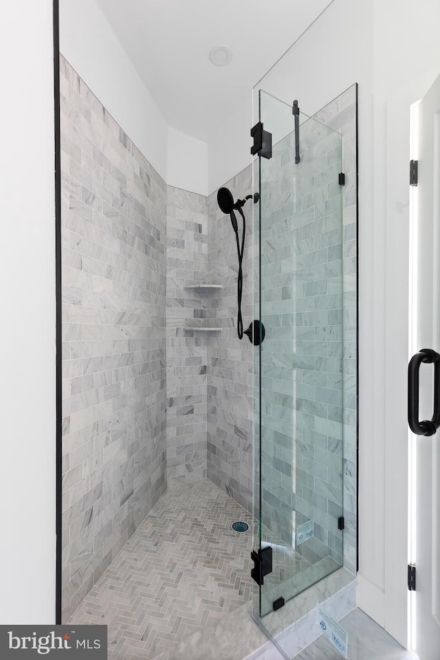 bathroom with a shower with door