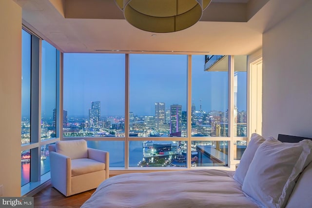 bedroom featuring expansive windows and parquet floors