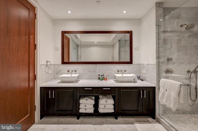 bathroom with backsplash, an enclosed shower, dual vanity, and tile flooring