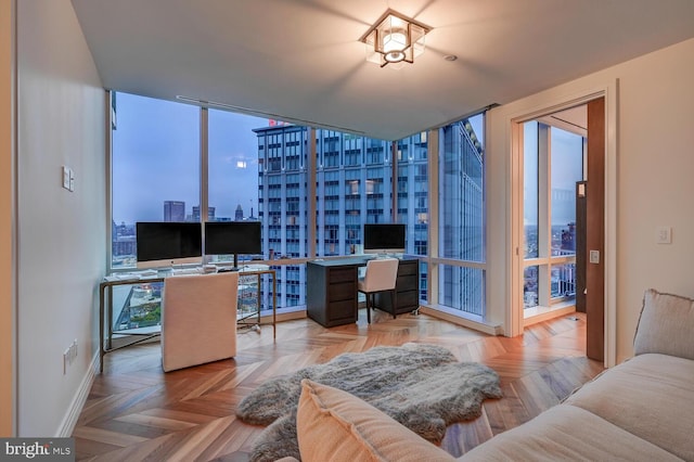 interior space with a healthy amount of sunlight, a wall of windows, and light parquet floors