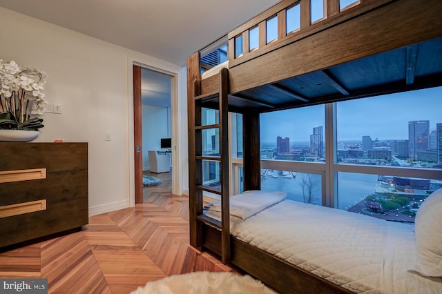 bedroom featuring light parquet floors and multiple windows