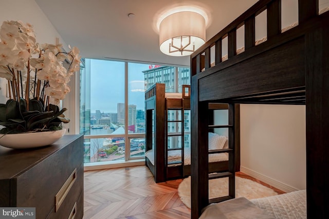 bedroom featuring light parquet flooring and expansive windows