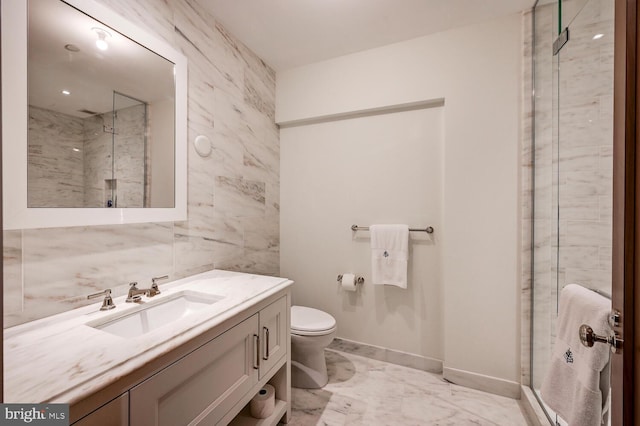 bathroom with oversized vanity, toilet, tile flooring, a shower with shower door, and tile walls