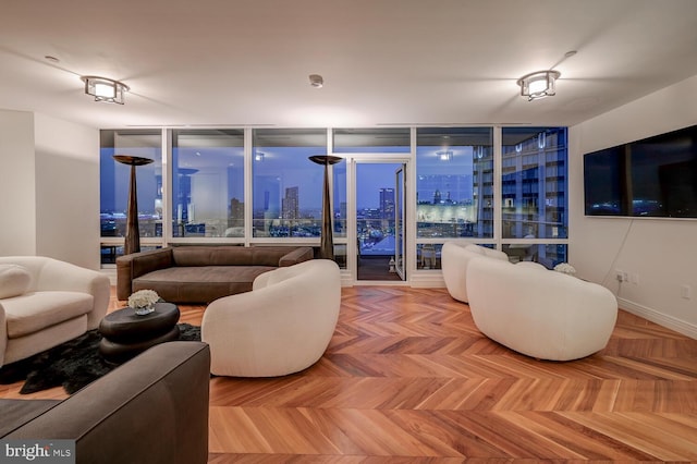 living room with light parquet floors and a wall of windows