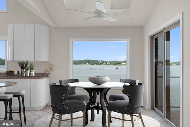 tiled dining room featuring vaulted ceiling, ceiling fan, and a wealth of natural light