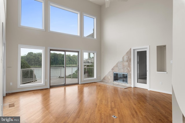 unfurnished living room with light hardwood / wood-style floors and a healthy amount of sunlight