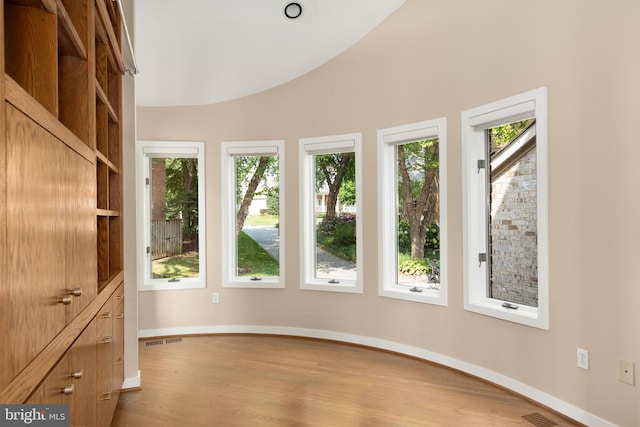 unfurnished sunroom with lofted ceiling