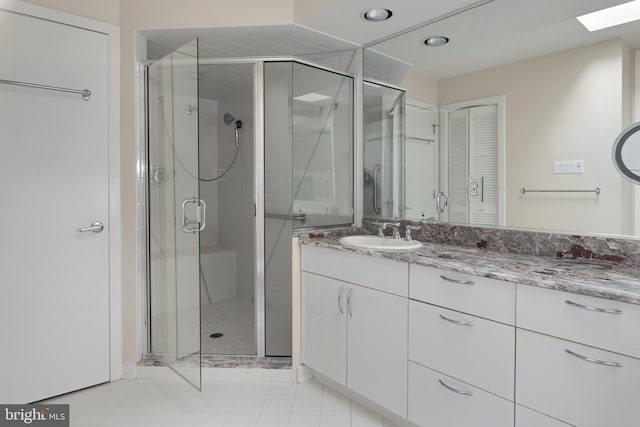 bathroom featuring walk in shower, tile floors, and vanity