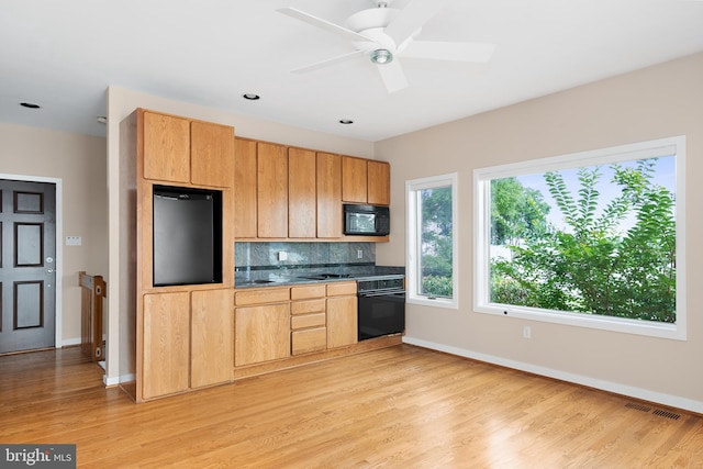 kitchen featuring ceiling fan, tasteful backsplash, black appliances, and light wood-type flooring