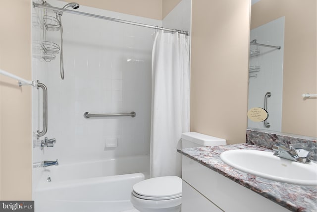 full bathroom with toilet, large vanity, and shower / tub combo