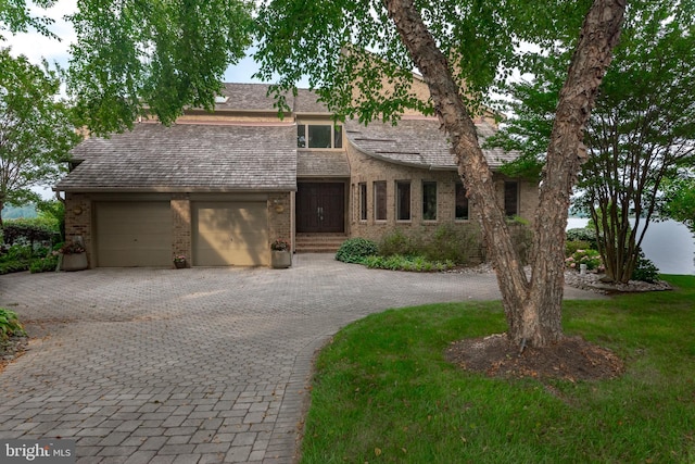 view of front of house with a front yard and a garage