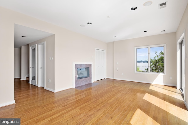 unfurnished living room with light hardwood / wood-style floors