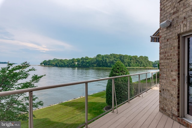 deck featuring a water view and a yard