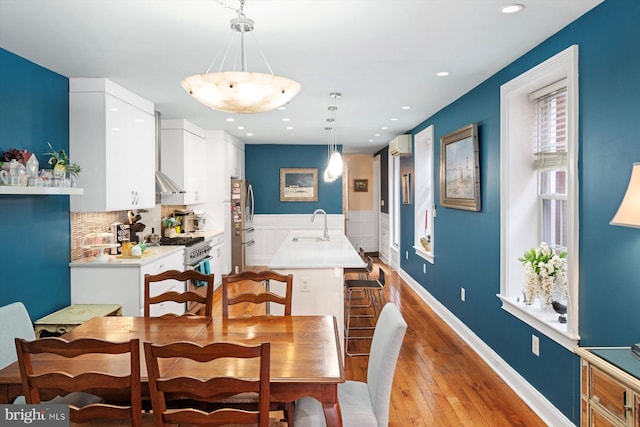 dining space with sink and light wood-type flooring