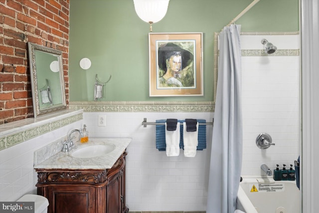 full bathroom with shower / bath combo, tile walls, toilet, tasteful backsplash, and vanity